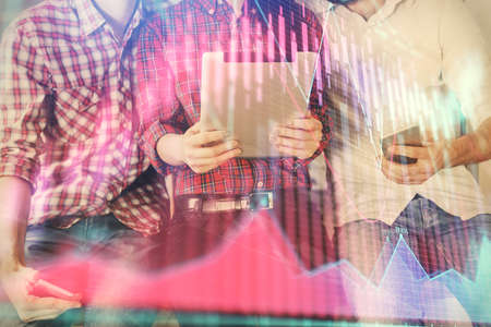 Double exposure of forex graph drawing and man and woman working together holding and using a mobile...