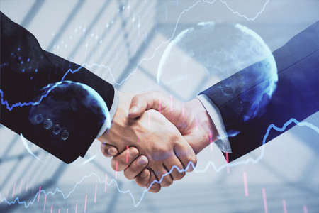 Double exposure of forex graph hologram and handshake of two men. Stock market concept.