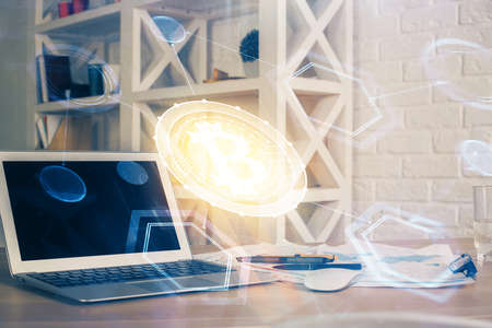 Double exposure of blockchain theme hologram and table with computer background. Concept of bitcoin crypto currency.の写真素材