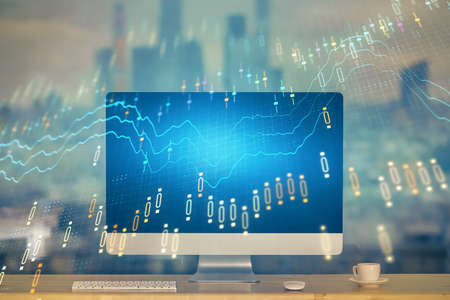 Stock market chart hologram drawn on personal computer background. Multi exposure. Concept of...