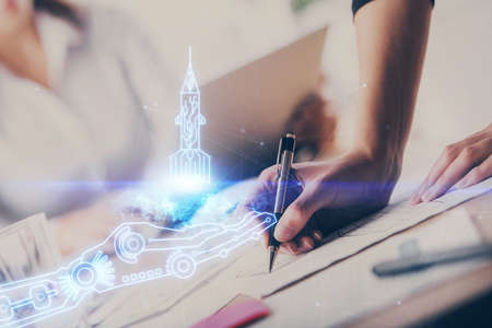 Start up creative drawing over close up hands in notepad background. Concept of brainstorming....