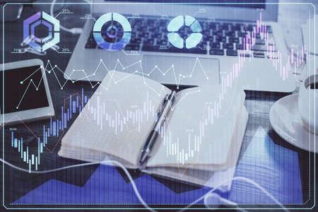 Multi exposure of financial graph drawings and desk with open notebook background. Concept of forex