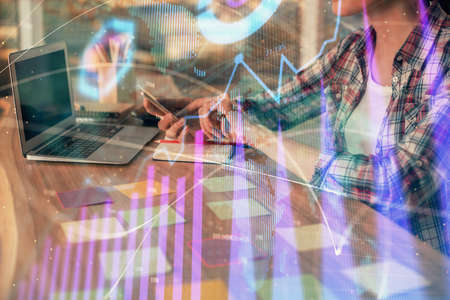 Double exposure of businesswoman hands typing on computer and forex graph hologram drawing....