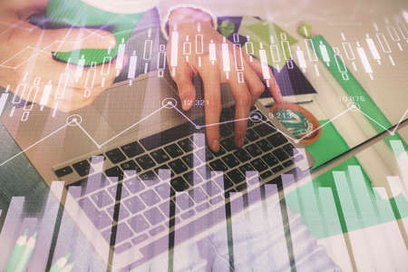 Double exposure of woman hands typing on computer and forex chart hologram drawing. Stock market...