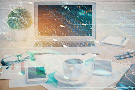 Double exposure of table with computer on background and data theme hologram. Data technology concept.の写真素材