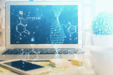 Desktop computer background and DNA drawing. Double exposure. Science concept.の写真素材