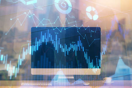 Forex market chart hologram and personal computer background. Double exposure. Concept of...
