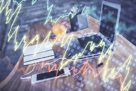 Forex market chart hologram and personal computer background. Double exposure. Concept of...