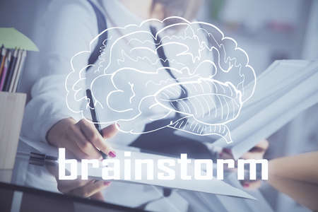 Start up creative drawing over close up hands in notepad background. Concept of brainstorming....