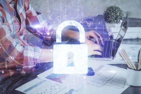 Multi exposure of lock icon with man working on computer on background. Concept of network...