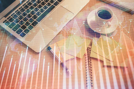 Stock market graph and top view computer on the table background. Double exposure. Concept of financial education.の写真素材