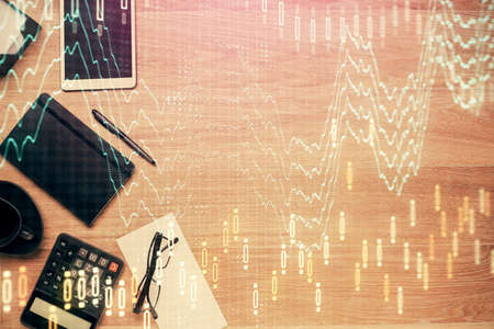 Double exposure of forex graph drawing and work table top veiw. Concept of financial analysis.