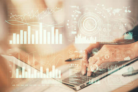 Double exposure of woman hands typing on computer and forex chart hologram drawing. Stock market...