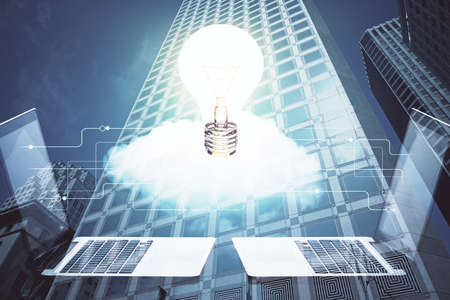 Multi exposure of bulb hologram drawing and cityscape background. Concept of idea.