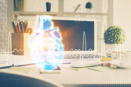 Desktop computer background and heart drawing. Double exposure. Medical study and healthcare concept.の写真素材