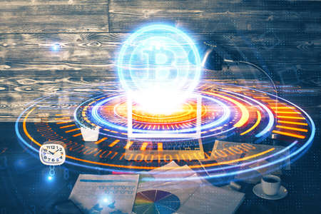 Double exposure of blockchain theme hologram and table with computer background. Concept of bitcoin crypto currency.の写真素材