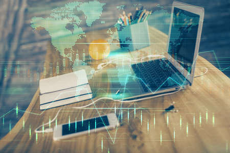 Double exposure of graph and financial info and work space with computer background. Concept of...