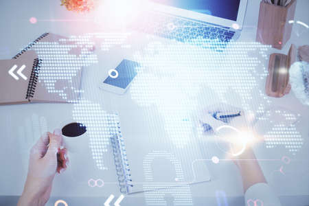 Multi exposure of hands making notes with world map hologram and data theme icons. Concept of global...