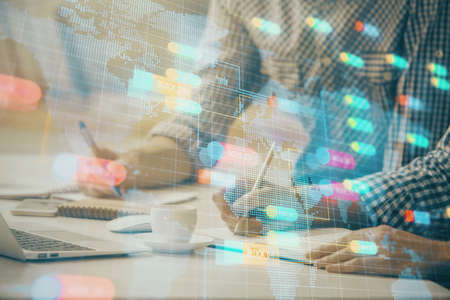 Businessman with computer background with technology theme hologram. Concept of hightech. Multi exposure.の写真素材