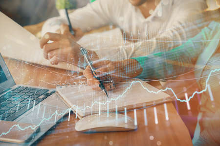 Double exposure of forex chart drawing over people taking notes background. Concept of financial...