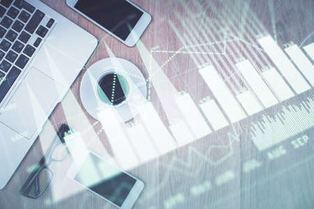 Multi exposure of financial chart hologram over desktop with phone. Top view. Mobile trade platform...