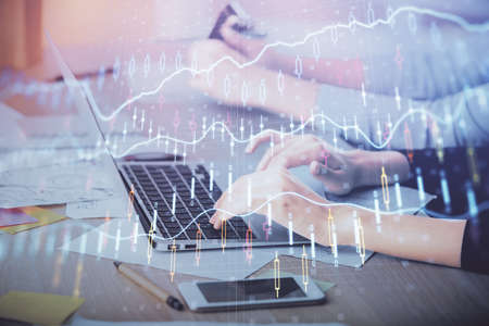 Multi exposure of woman hands typing on computer and financial chart hologram drawing. Stock market...
