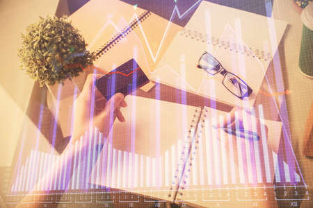 Multi exposure of woman on-line shopping holding a credit card and financial graph drawing. Stock market E-commerce concept.の写真素材