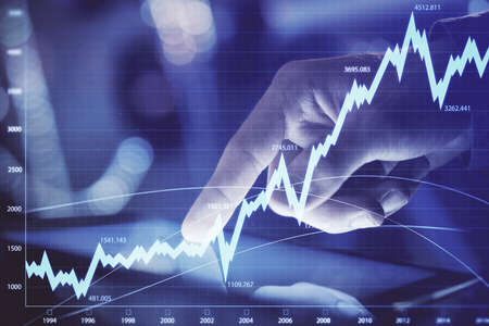 Multi exposure of mans hands holding and using a phone and financial chart drawing. Market analysis...