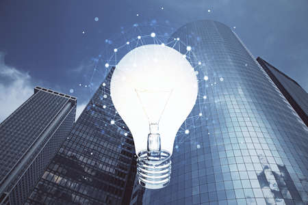 Multi exposure of bulb hologram drawing and cityscape background. Concept of idea.