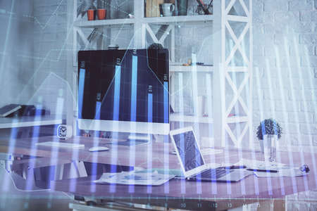 Forex market chart hologram and personal computer background. Double exposure. Concept of investment.の写真素材