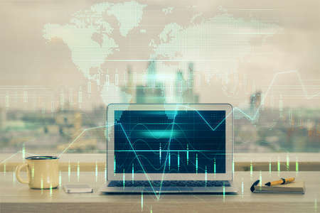 Double exposure of chart and financial info and work space with computer background. Concept of international online trading.の写真素材