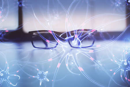 Neuron drawing with glasses on the table background. Concept of human brain. Double exposure.