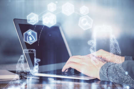 Technology theme hologram with man working on computer on background. High tech concept. Double...