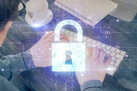 Multi exposure of lock icon with man working on computer on background. Concept of network...
