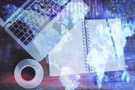 Financial market graph and top view computer on the desktop background. Double exposure. Investment...