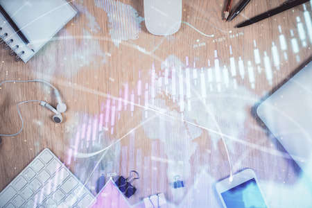 Multi exposure of forex graph hologram over desktop with phone. Top view. Mobile trade platform concept.の写真素材