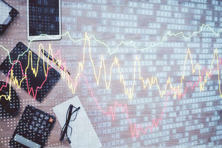 Double exposure of forex graph drawing and work table top veiw. Concept of financial analysis.