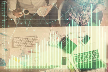Double exposure of man and woman working together and financial chart hologram drawing. market...