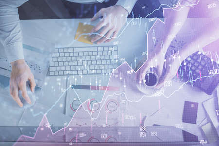 Double exposure of man and woman working together and financial chart hologram drawing. market...