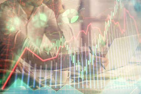 Multi exposure of man and woman working together and financial chart hologram. Business concept....