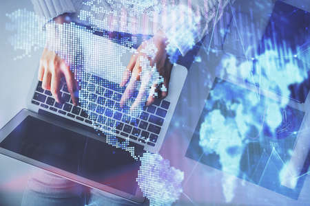 Multi exposure of woman hands working on computer and forex chart hologram drawing. Top View....