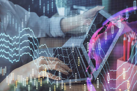 Double exposure of woman hands typing on computer and forex chart hologram drawing. Stock market...