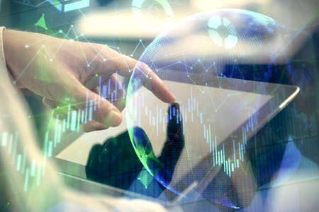Multi exposure of mans hands holding and using a phone and financial chart drawing. Market analysis...