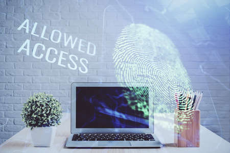 Computer on desktop in office with finger print drawing. Double exposure. Concept of business data...