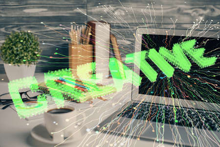 Desktop computer background in office and start up theme hologram drawing. Double exposure. Startup...
