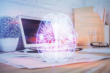 Double exposure of work space with computer and human brain drawing hologram. Brainstorm concept.