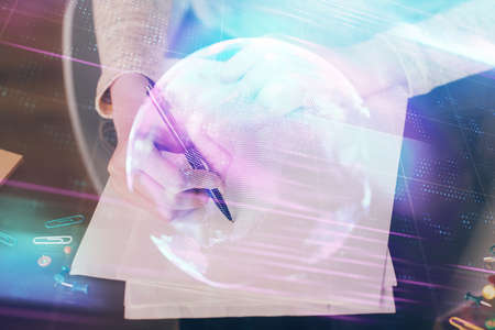 Technology theme hologram over womans hands taking notes background. Concept of Tech. Double exposureの写真素材