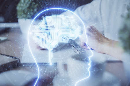 Multi exposure of writing hand on background with brain hologram. Concept of self learning.の写真素材
