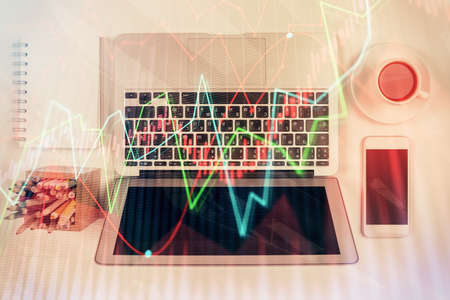 Stock market chart and top view computer on the table background. Multi exposure. Concept of...