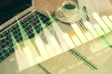 Multi exposure of forex graph drawing and desktop with coffee and items on table background. Concept...